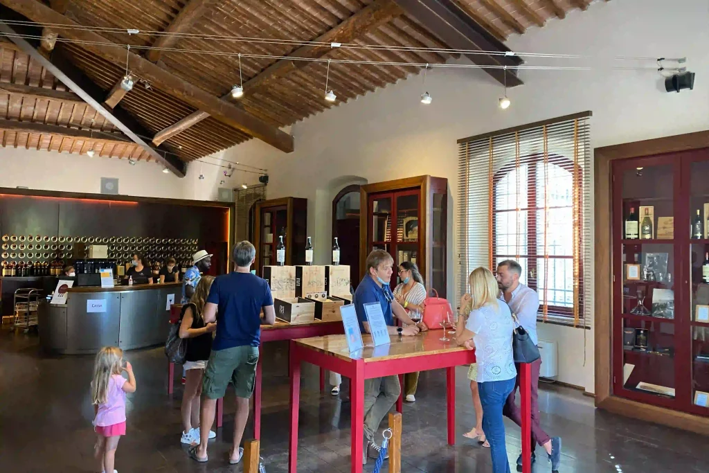 Wine tasting experience inside Brolio Castle's historic wine shop with visitors exploring the room